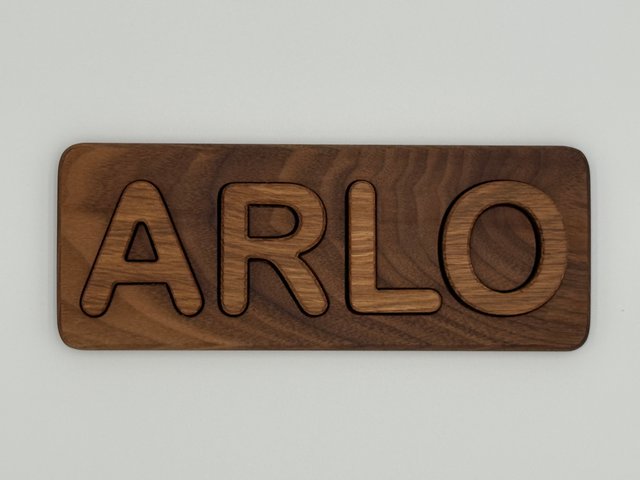 Finished ARLO puzzle photographed straight on, showing its natural grain