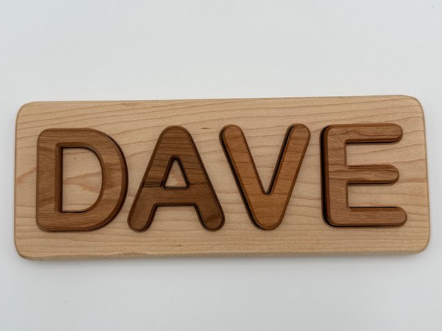 Finished DAVE puzzle photographed straight on, with a light board and darker letters