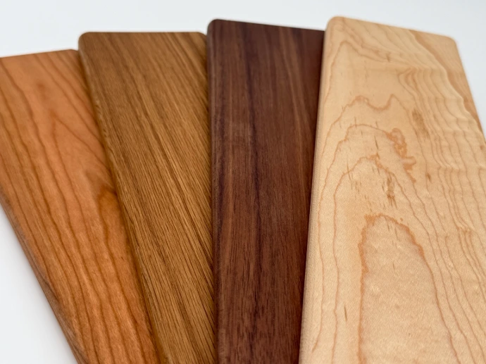 Four hardwood boards showing natural variations in color and grain