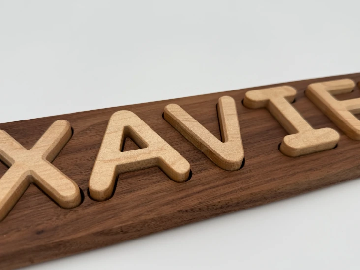 Walnut board with maple letters — detail