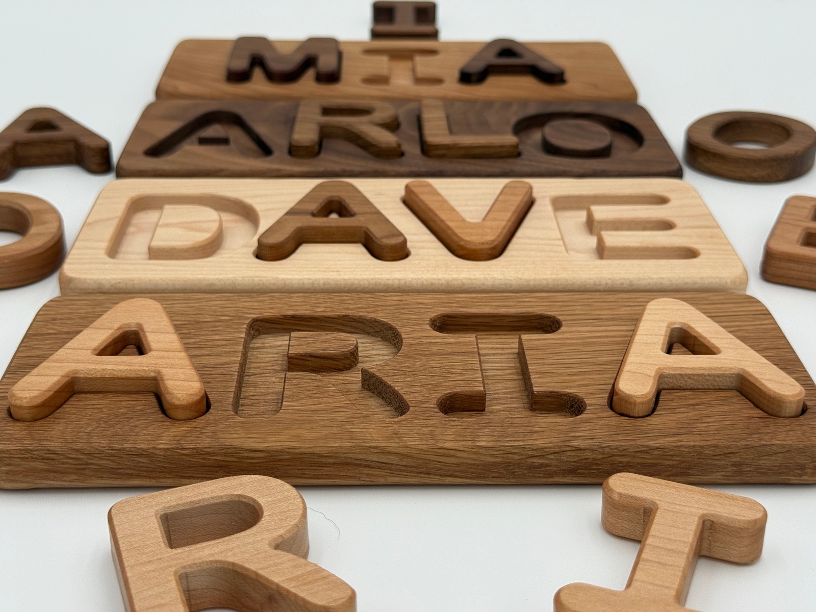 Close view of hardwood letters, grain and puzzle recesses